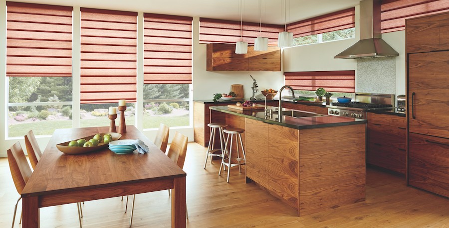 A dining room featuring two windows with Hunter Douglas motorized blinds. 