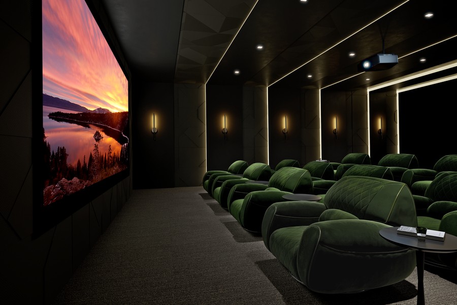 A home theater with a large movie screen, Sony projector, and plush, tiered seating.