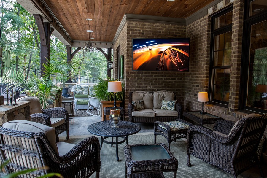 An outdoor covered patio featuring a wall-mounted SunBrite TV. 
