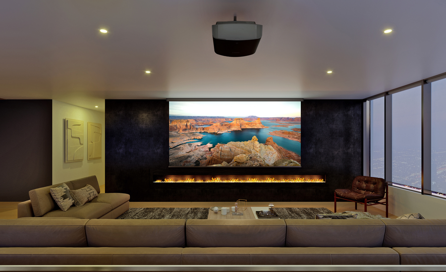 A home theater featuring a large screen, a projector, a fireplace, and motorized shades covering the window.