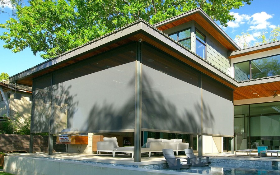 Screen Innovation’s outdoor motorized shades surrounding a patio.